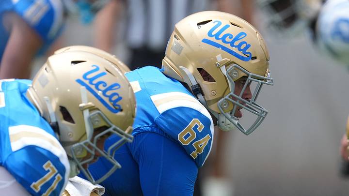 May 2, 2026; Pasadena, CA, USA; A general overall view of helmets at the line of scrimmage as UCLA Bruins center Sam Yoon (64) snaps the ball during the spring game at Rose Bowl. Mandatory Credit: Kirby Lee-Imagn Images