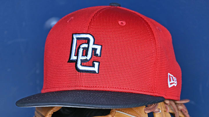 Aug 12, 2025; Kansas City, Missouri, USA;  A Washington Nationals hat and glove in the dugout before a game against the Kansas City Royals at Kauffman Stadium.