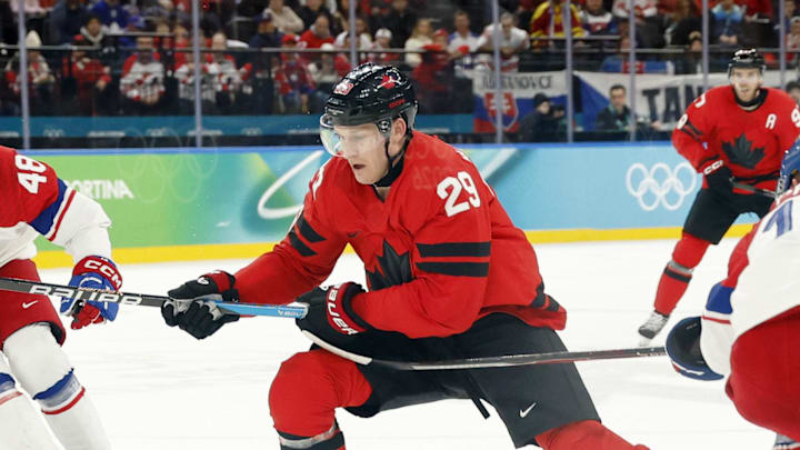 Feb 18, 2026; Milan, Italy; Nathan MacKinnon of Canada chases after the puck against Ondrej Palat of Czechia in a men's ice hockey quarterfinal during the Milano Cortina 2026 Olympic Winter Games at Milano Santagiulia Ice Hockey Arena. Mandatory Credit: Geoff Burke-Imagn Images