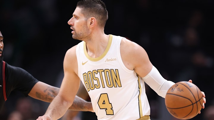 Mar 1, 2026; Boston, Massachusetts, USA; Boston Celtics center Nikola Vucevic (4) dribbles down the court defended by Philadelphia 76ers center Andre Drummond (1) during the first half at TD Garden. Mandatory Credit: Paul Rutherford-Imagn Images