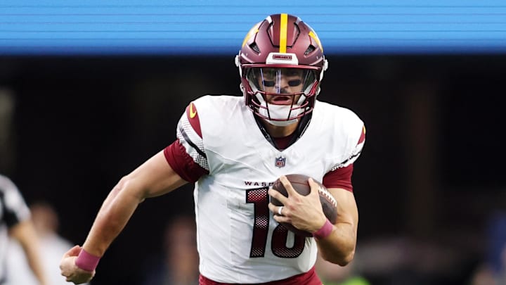 Jan 5, 2025; Arlington, Texas, USA; Washington Commanders quarterback Marcus Mariota (18) runs for a first down against the Dallas Cowboys during the fourth quarter at AT&T Stadium. Mandatory Credit: Tim Heitman-Imagn Images