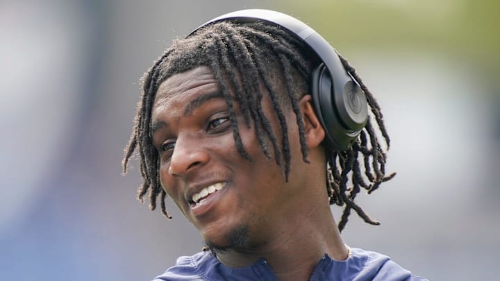 Tennessee Titans quarterback Cam Ward chats with teammates during warmups before the game against the Indianapolis Colts.