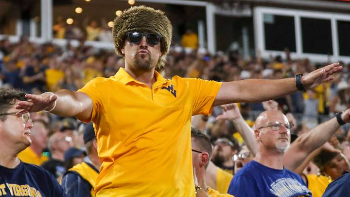 Sep 19, 2026; Charlotte, North Carolina, USA; West Virginia Mountaineers fans cheer during the fourth quarter against the Virginia Cavaliers at Bank of America Stadium. Mandatory Credit: Ben Queen-Imagn Images