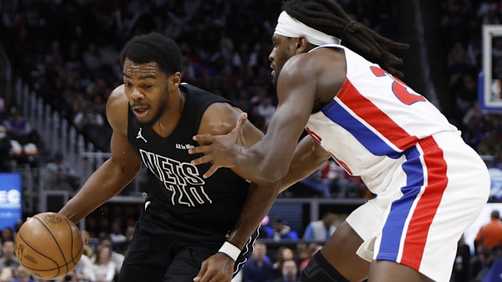 Feb 1, 2026; Detroit, Michigan, USA;  Brooklyn Nets center Day'ron Sharpe (20) dribbles defended by Detroit Pistons forward Isaiah Stewart (28) in the first half at Little Caesars Arena. Mandatory Credit: Rick Osentoski-Imagn Images