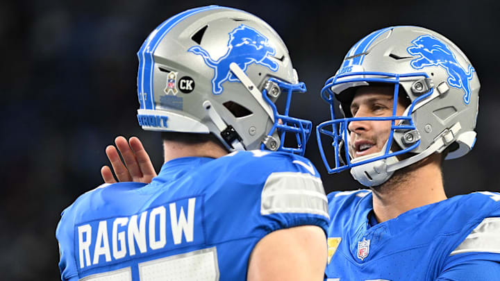 Detroit Lions quarterback Jared Goff (16) greets center Frank Ragnow (77).