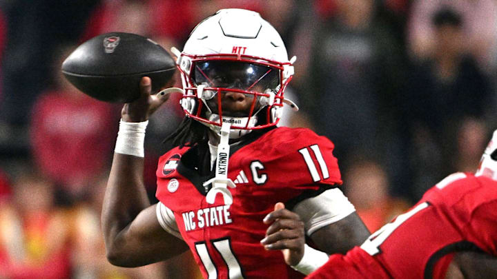 Nov 1, 2025; Raleigh, North Carolina, USA;  North Carolina State Wolfpack quarterback CJ Bailey (11) throws a pass during the first quarter against the Georgia Tech Yellow Jackets at Carter-Finley Stadium. Mandatory Credit: Zachary Taft-Imagn Images