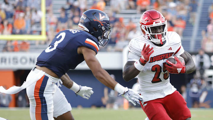 Oct 12, 2024; Charlottesville, Virginia, USA; Louisville Cardinals running back Isaac Brown (25) carries the ball past Virginia Cavaliers safety Corey Thomas Jr. (3) to score a touchdown during the second half at Scott Stadium. Mandatory Credit: Amber Searls-Imagn Images Oct 12, 2024; Charlottesville, Virginia, USA; Louisville Cardinals running back Isaac Brown (25) carries the ball past Virginia Cavaliers safety Corey Thomas Jr. (3) to score a touchdown during the second half at Scott Stadium. Mandatory Credit: Amber Searls-Imagn Images