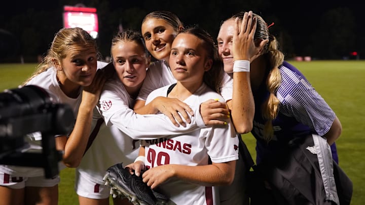 Arkansas senior forward Zoe Susi is surrounded by her teammates during a post-game interview after defeating Texas A&M on Sunday.
