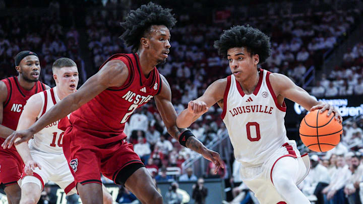 Louisville Cardinals guard Mikel Brown Jr. (0) drives as NC State Wolfpack guard Jr. Paul McNeil (2) defends during the Cards' win in ACC basketball on February 9, 2026 in Louisville, Kentucky.