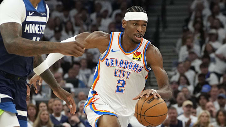 Oklahoma City Thunder guard Gilgeous-Alexander dribbles the ball past Minnesota Timberwolves center Reid during game four of the Western Conference finals.