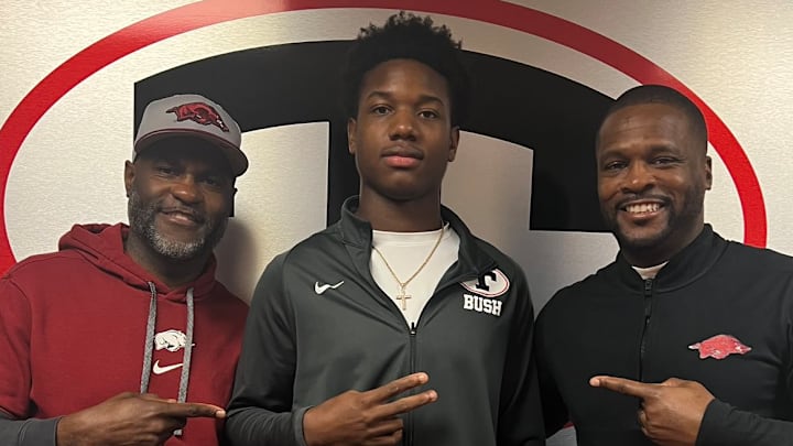 Theodore, Alabama 4-star linebacker Jaden Bush (center) with Arkansas Razorbacks co-defensive coordinator Marcus Woodson (left) and defensive coordinator Travis Williams (right) during a recruiting visit in January.