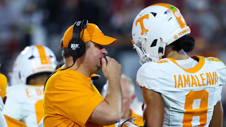 Tennessee Volunteers coach Josh Heupel speaks with Tennessee Volunteers quarterback Nico Iamaleava (8) during the first half against the Oklahoma Sooners at Gaylord Family-Oklahoma Memorial Stadium.