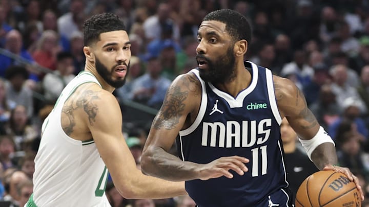 Jan 25, 2025; Dallas, Texas, USA;  Dallas Mavericks guard Kyrie Irving (11) drives to the basket as Boston Celtics forward Jayson Tatum (0) defends during the first half at American Airlines Center. Mandatory Credit: Kevin Jairaj-Imagn Images