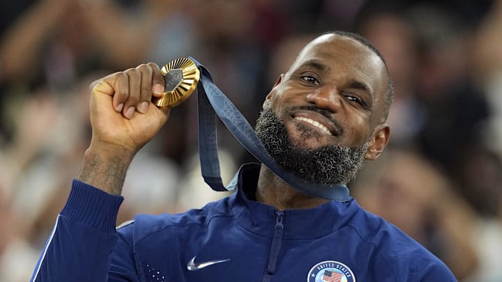 United States guard LeBron James celebrates with the gold medal after the game against France during the Paris 2024 Olympic Summer Games.