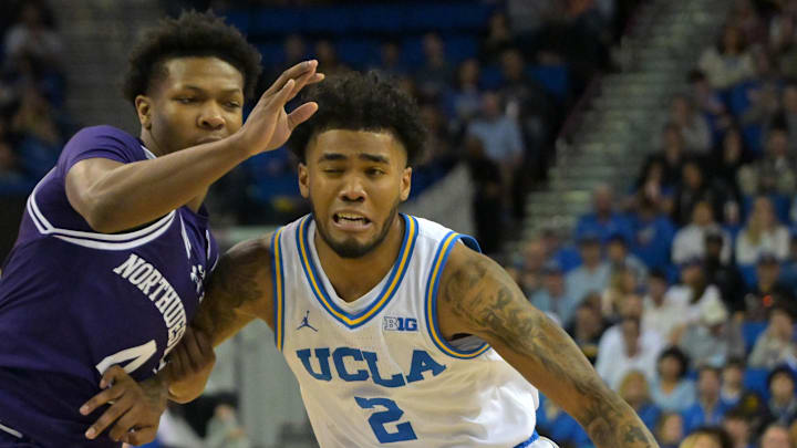 Jan 24, 2026; Los Angeles, California, USA; Northwestern Wildcats guard Jayden Reid (4) UCLA Bruins guard Donovan Dent (2) as he drives to the basket in the first half at Pauley Pavilion presented by Wescom Financial. Mandatory Credit: Jayne Kamin-Oncea-Imagn Images