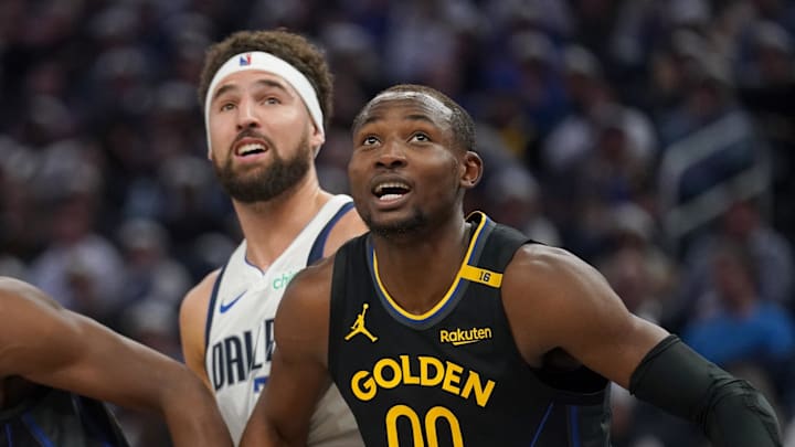 Nov 12, 2024; San Francisco, California, USA; Golden State Warriors forward Jonathan Kuminga (00) and forward Andrew Wiggins (22) battle for position with Dallas Mavericks guard Klay Thompson (31) in the second quarter at the Chase Center. Mandatory Credit: Cary Edmondson-Imagn Images