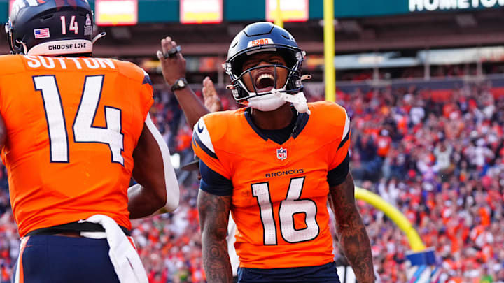 Oct 13, 2024; Denver, Colorado, USA; Denver Broncos wide receiver Troy Franklin (16) celebrates the touchdown by wide receiver Courtland Sutton (14) in the second half against the Los Angeles Chargers at Empower Field at Mile High. Mandatory Credit: Ron Chenoy-Imagn Images
