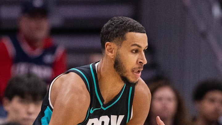 Portland Trail Blazers forward Kris Murray drives on Charlotte Hornets guard LaMelo Ball. Portland Trail Blazers forward Kris Murray drives on Charlotte Hornets guard LaMelo Ball.