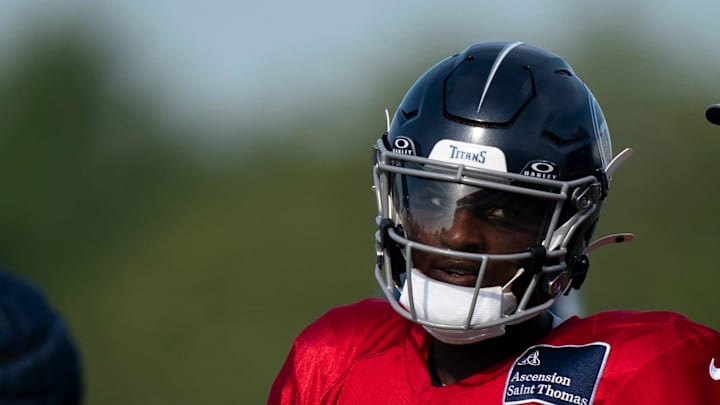 Tennessee Titans quarterback Cam Ward works with quarterbacks coach Bo Hardegree during training camp.