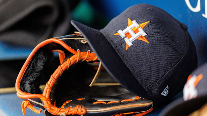 Apr 27, 2025; Kansas City, Missouri, USA; Houston Astros hat and glove in the dugout during the second inning against the Kansas City Royals at Kauffman Stadium. 
