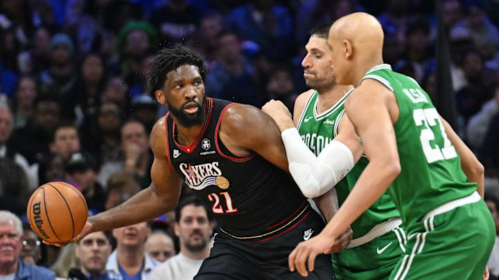 Apr 26, 2026; Philadelphia, Pennsylvania, USA; Philadelphia 76ers center Joel Embiid (21) is defended by Boston Celtics center Nikola Vucevic (4) during the first half at Xfinity Mobile Arena. Mandatory Credit: Eric Hartline-Imagn Images