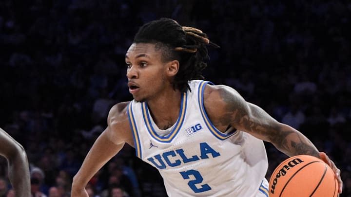 Dec 21, 2024; New York, NY, USA; UCLA Bruins guard Dylan Andrews (2) drives to the basket while being defended by North Carolina Tar Heels guard Drake Powell (9) during the first half at Madison Square Garden. Mandatory Credit: John Jones-Imagn Images