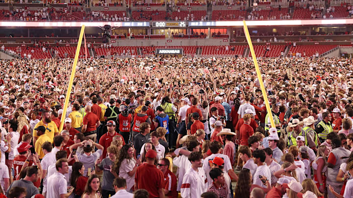 Arkansas Razorbacks fans celebrate in front of the downed goal posts after the game against the Tennessee Volunteers at Donald W. Reynolds Razorback Stadium. Arkansas won 19-14.