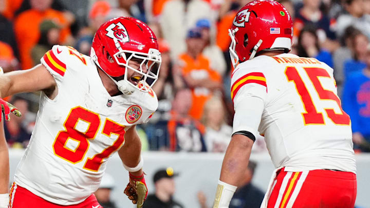 Nov 16, 2025; Denver, Colorado, USA; Kansas City Chiefs tight end Travis Kelce (87) celebrates his touchdown with quarterback Patrick Mahomes (15) and tight end Robert Tonyan (85) in the fourth quarter at Empower Field at Mile High. Mandatory Credit: Ron Chenoy-Imagn Images