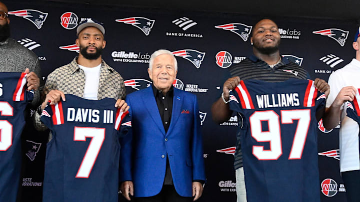 Mar 13, 2025; Foxborough, MA, USA; The New England Patriots hold a press conference at the GP Atrium at Gillette Stadium to introduce free agency additions to the team. (Left to right) New England Patriots head coach Mike Vrabel, offensive tackle Morgan Moses, cornerback Carlton Davis III, owner Robert Kraft, defensive tackle Milton Williams, linebacker Robert Spillane and executive vice president of player personnel Eliot Wolf. Mandatory Credit: Eric Canha-Imagn Images