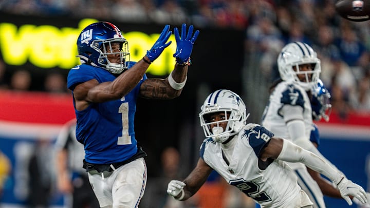 Sep 26, 2024; East Rutherford, NJ, US; New York Giants wide receiver Malik Nabers (1) catches a pass in the fourth quarter before being tackled by Dallas Cowboys cornerback Jourdan Lewis (2) at MetLife Stadium. Mandatory Credit: Julian Guadalupe-NorthJersey.com