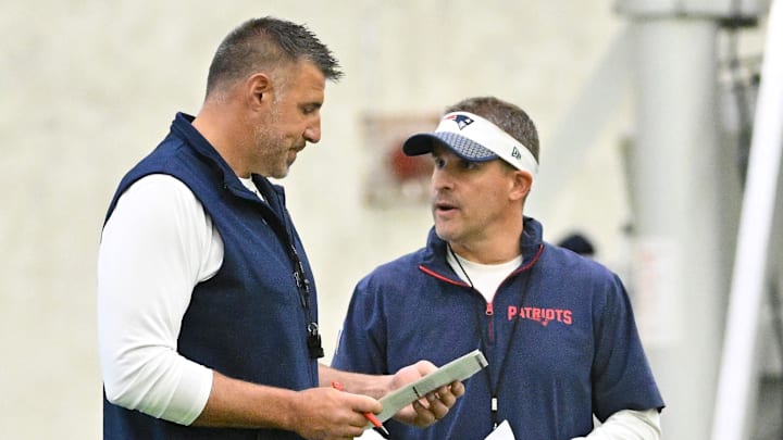 Jun 10, 2025; Foxborough, MA, USA; New England Patriots head coach Mike Vrabel (l) and offensive coordinator Josh McDaniels (r) speak to each other during minicamp held in the WIN Field House at Gillette Stadium. Mandatory Credit: Eric Canha-Imagn Images