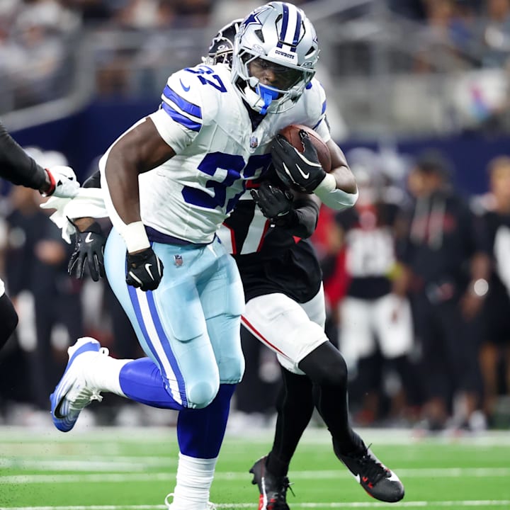Dallas Cowboys running back Phil Mafah runs with the ball as Atlanta Falcons cornerback Dontae Manning defends.