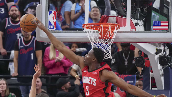 Apr 9, 2025; Inglewood, California, USA; Houston Rockets center N'Faly Dante (3) block Los Angeles Clippers guard Bogdan Bogdanovic (10) in the second half at Intuit Dome. Mandatory Credit: Kirby Lee-Imagn Images