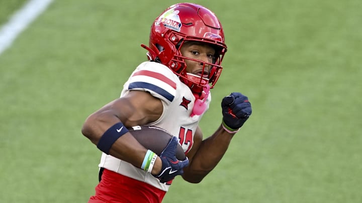 Oct 18, 2025; Houston, Texas, USA; Arizona Wildcats wide receiver Tre Spivey (12) runs the ball during the first quarter against the Houston Cougars at TDECU Stadium. Mandatory Credit: Maria Lysaker-Imagn Images 