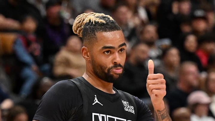Jan 1, 2025; Toronto, Ontario, CAN;  Brooklyn Nets guard D'Angelo Russell (1) reacts to an official's call as Toronto Raptors guard Ochai Agbaji (30) looks on in the second half at Scotiabank Arena. Mandatory Credit: Dan Hamilton-Imagn Images