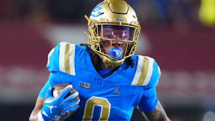 Nov 29, 2025; Los Angeles, California, USA; UCLA Bruins running back Jalen Berger (0) carries the ball against Southern California Trojans safety Kennedy Urlacher (28) in the first half at United Airlines Field at Los Angeles Memorial Coliseum. Mandatory Credit: Kirby Lee-Imagn Images Nov 29, 2025; Los Angeles, California, USA; UCLA Bruins running back Jalen Berger (0) carries the ball against Southern California Trojans safety Kennedy Urlacher (28) in the first half at United Airlines Field at Los Angeles Memorial Coliseum. Mandatory Credit: Kirby Lee-Imagn Images
