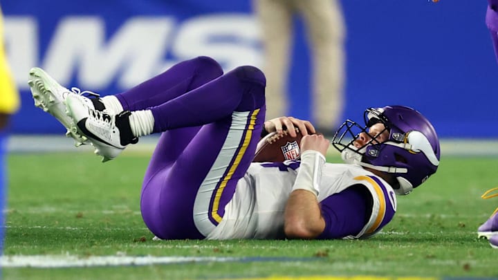 Minnesota Vikings quarterback Sam Darnold lays on the field after being sacked.