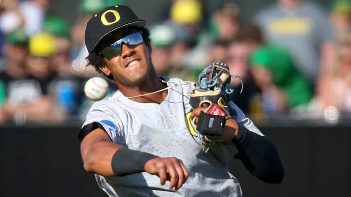 Oregon infielder Sabin Ceballos throws to first for an out in the first inning during an NCAA college baseball tournament Super Regional game Saturday, June 10, 2023, in Eugene, Ore. Oral Roberts won 8-7.