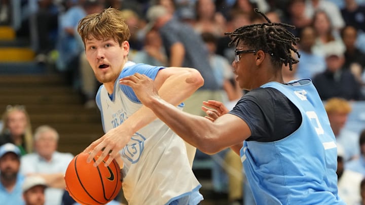 Oct 4, 2025; Charlotte, NC, USA; North Carolina Tar Heels center Henri Veesaar (13) with the ball as forward James Brown (2) defends in the first half at Dean E. Smith Center. Mandatory Credit: Bob Donnan-Imagn Images