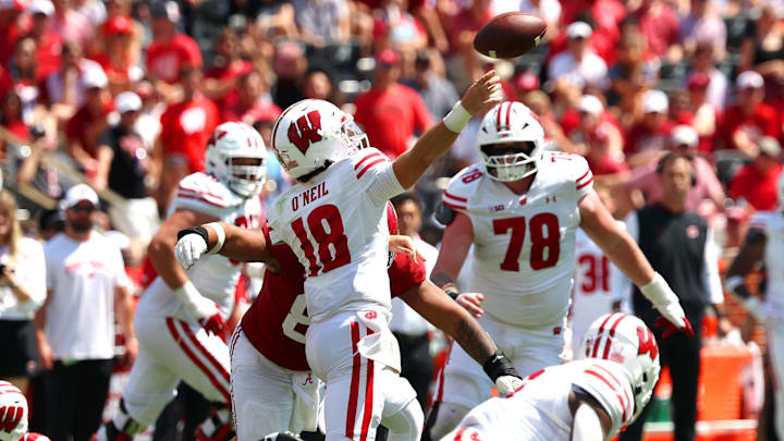 Sep 13, 2025; Tuscaloosa, Alabama, USA; Wisconsin Badgers quarterback Danny O'Neil (18) is sacked by Alabama Crimson Tide linebacker Justin Hill (8) during the second half at Saban Field at Bryant-Denny Stadium. Mandatory Credit: David Leong-Imagn Images