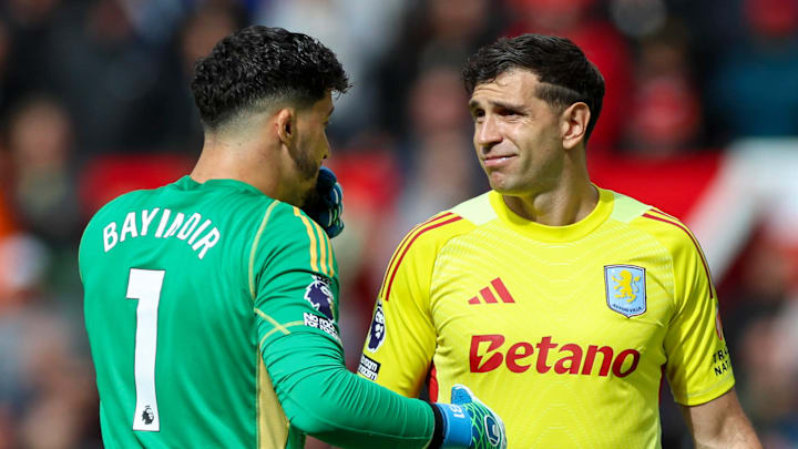 Emiliano Martinez (right) shares words with Man Utd goalkeeper Altay Bayındır (left).