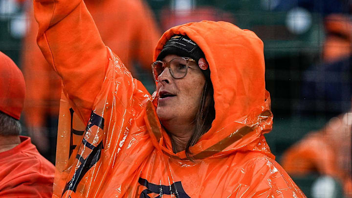 Baseball fans cheer on as Detroit Tigers grounds crew get ready to take the tarp off the field due to rain delay during ALDS Game 3 at Comerica Park in Detroit on Tuesday, Oct. 7, 2025.
