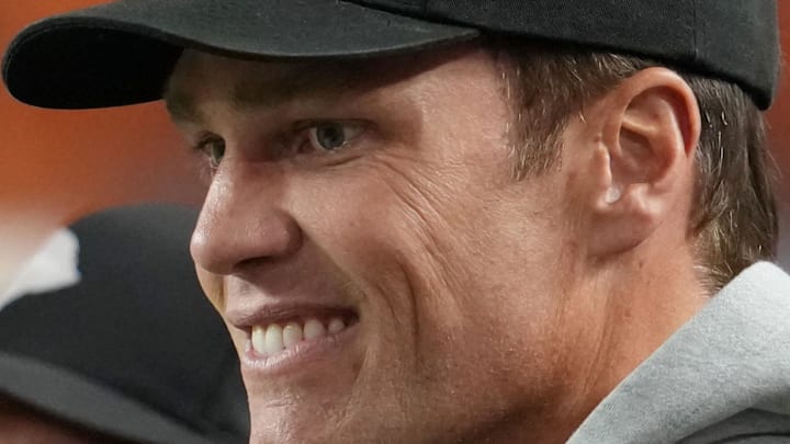 Jan 19, 2026; Miami Gardens, FL, USA; Tom Brady looks on from the sideline before the CFP National Championship college football game between the Indiana Hoosiers and the Miami Hurricanes at Hard Rock Stadium. Mandatory Credit: Kirby Lee-Imagn Images