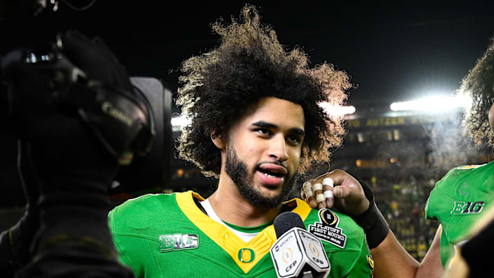 Dec 20, 2025; Eugene, OR, USA;  Oregon Ducks quarterback Dante Moore (5) is interviewed after the game against the James Madison Dukes at Autzen Stadium. Mandatory Credit: Troy Wayrynen-Imagn Images