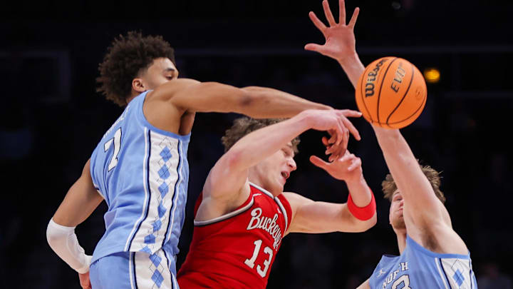 Dec 20, 2025; Atlanta, Georgia, USA; North Carolina Tar Heels guard Seth Trimble (7) and center Henri Veesaar (13) defend Ohio State Buckeyes center Christoph Tilly (13) in the second half at State Farm Arena. Mandatory Credit: Brett Davis-Imagn Images
