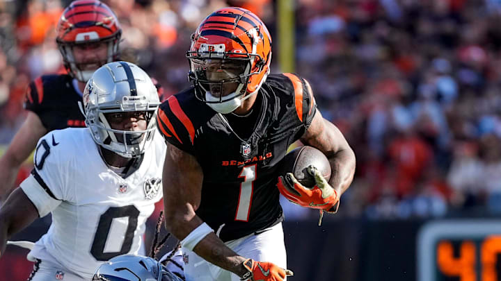 Cincinnati Bengals wide receiver Ja'Marr Chase (1) fights a tackle from Las Vegas Raiders safety Tre'von Moehrig (7) and cornerback Jakorian Bennett (0) on a catch in the second quarter of the NFL Week 9 game between the Cincinnati Bengals and the Las Vegas Raiders at Paycor Stadium in downtown Cincinnati on Sunday, Nov. 3, 2024.