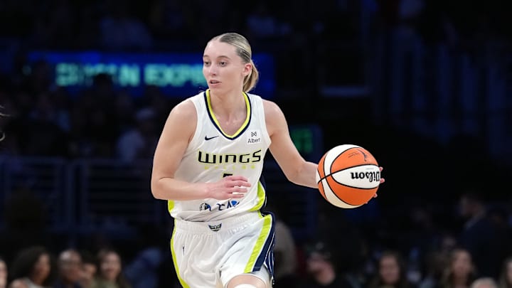 Aug 20, 2025; Los Angeles, California, USA; Dallas Wings guard Paige Bueckers (5) dribbles the ball against LA Sparks forward Cameron Brink (22) in the first half at Crypto.com Arena. Mandatory Credit: Kirby Lee-Imagn Images