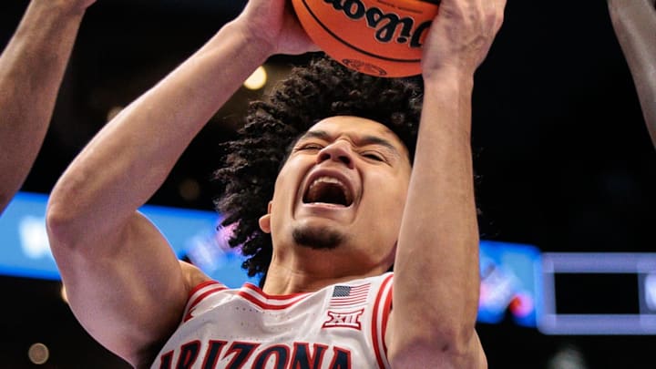 Mar 12, 2026; Kansas City, MO, USA; Arizona Wildcats guard Brayden Burries (5) rebounds around UCF Knights guard Themus Fulks (1) during the first half at T-Mobile Center. Mandatory Credit: William Purnell-Imagn Images Mar 12, 2026; Kansas City, MO, USA; Arizona Wildcats guard Brayden Burries (5) rebounds around UCF Knights guard Themus Fulks (1) during the first half at T-Mobile Center. Mandatory Credit: William Purnell-Imagn Images