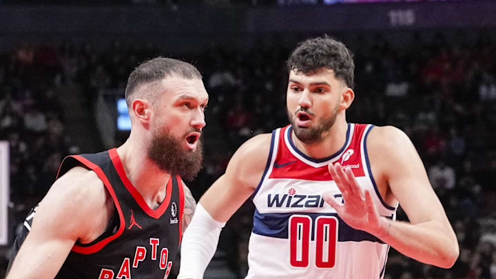 Sandro Mamukelashvili of the Toronto Raptors dribbles against Tristan Vukcevic of the Washington Wizards.