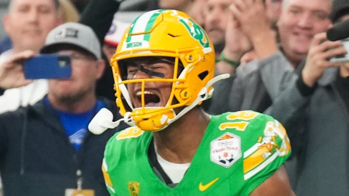 Jan 1, 2024; Glendale, AZ, USA; Oregon Ducks tight end Kenyon Sadiq (18) reacts after scoring a touchdown against the Liberty Flames in the second quarter of the 2024 Fiesta Bowl at State Farm Stadium. Mandatory Credit: Joe Camporeale-Imagn Images